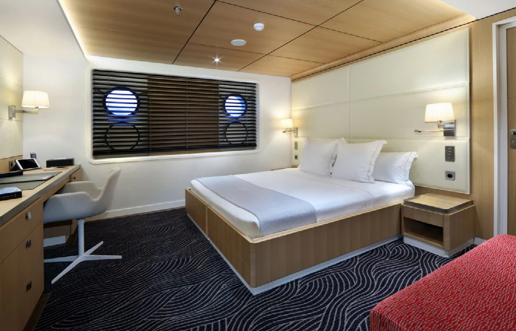 a room with a bed and a desk aboard YERSIN Yacht for Charter