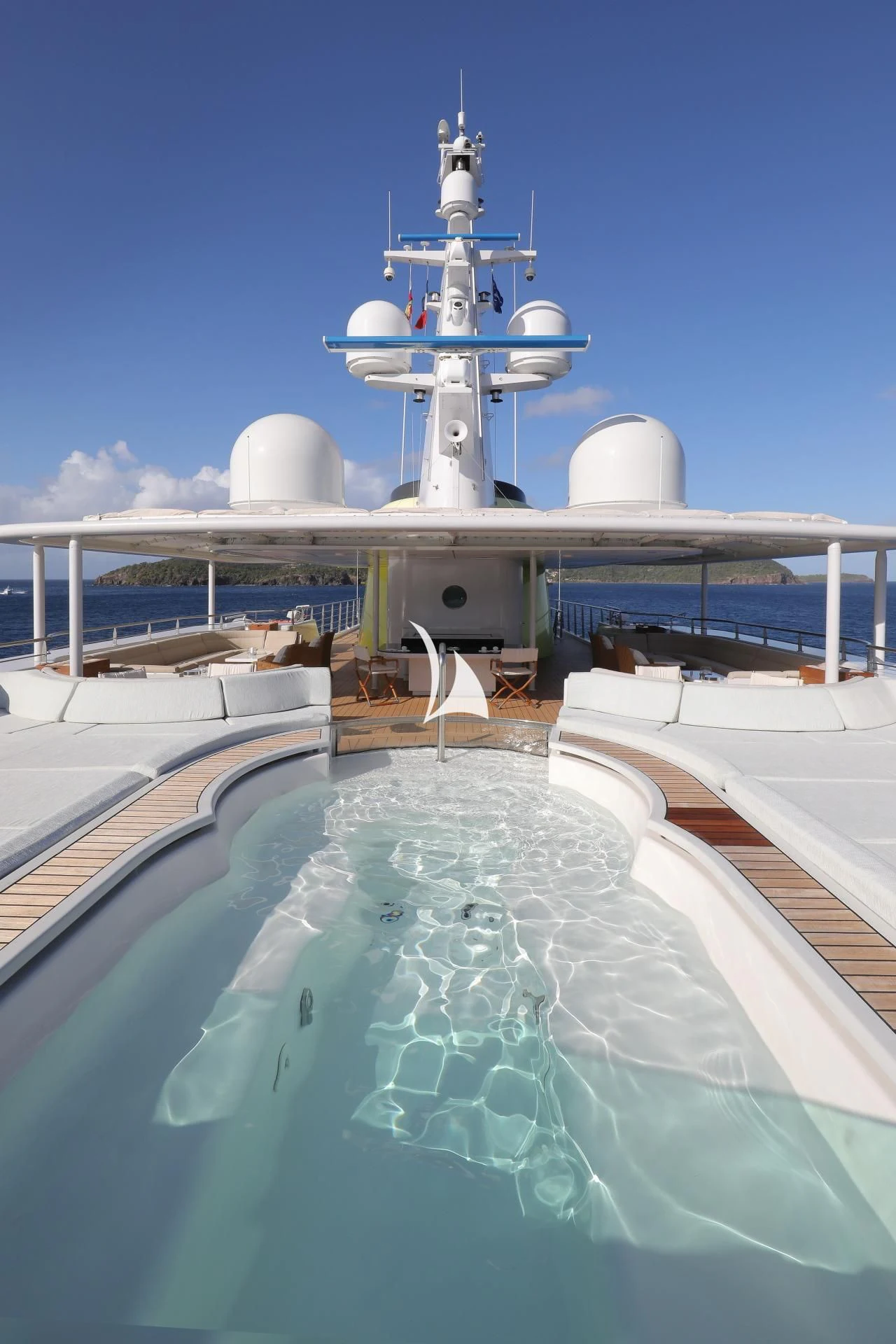 a large white and blue space shuttle on top of a blue water slide aboard YERSIN Yacht for Charter