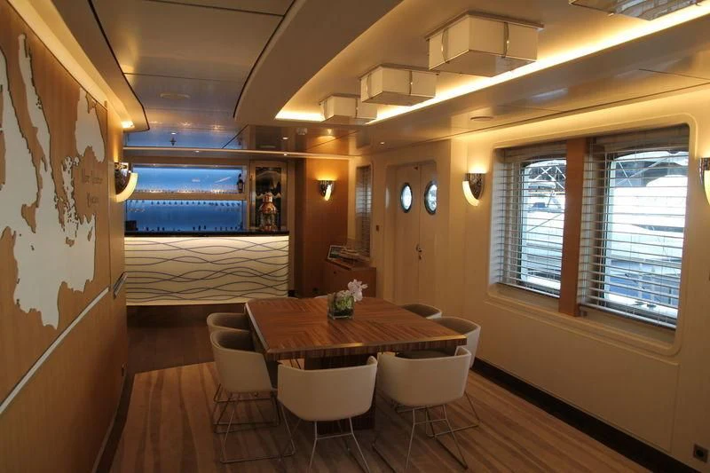 a dining room with a table and chairs aboard YERSIN Yacht for Charter