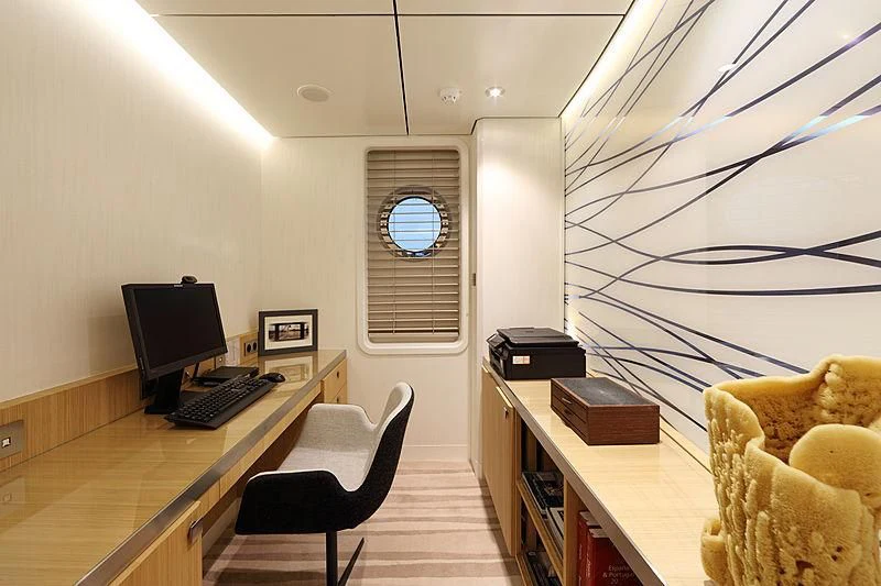 a room with a desk and computer aboard YERSIN Yacht for Charter