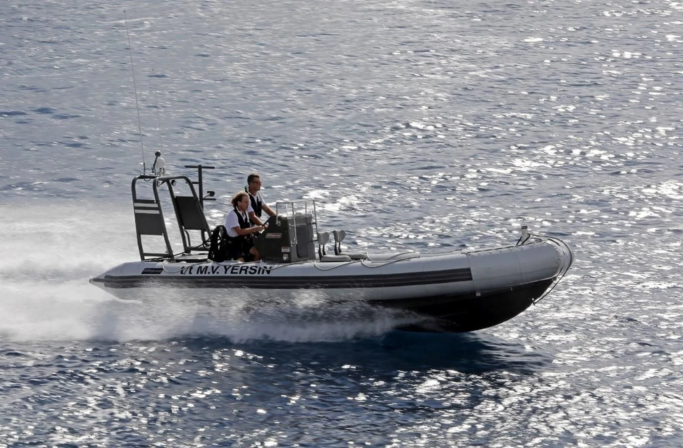 a man driving a boat aboard YERSIN Yacht for Charter