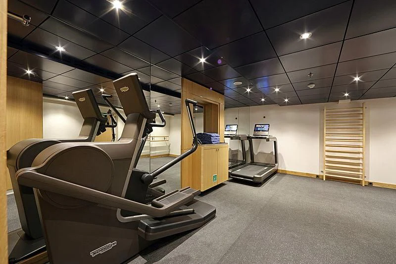 a room with treadmills and a large mirror aboard YERSIN Yacht for Charter