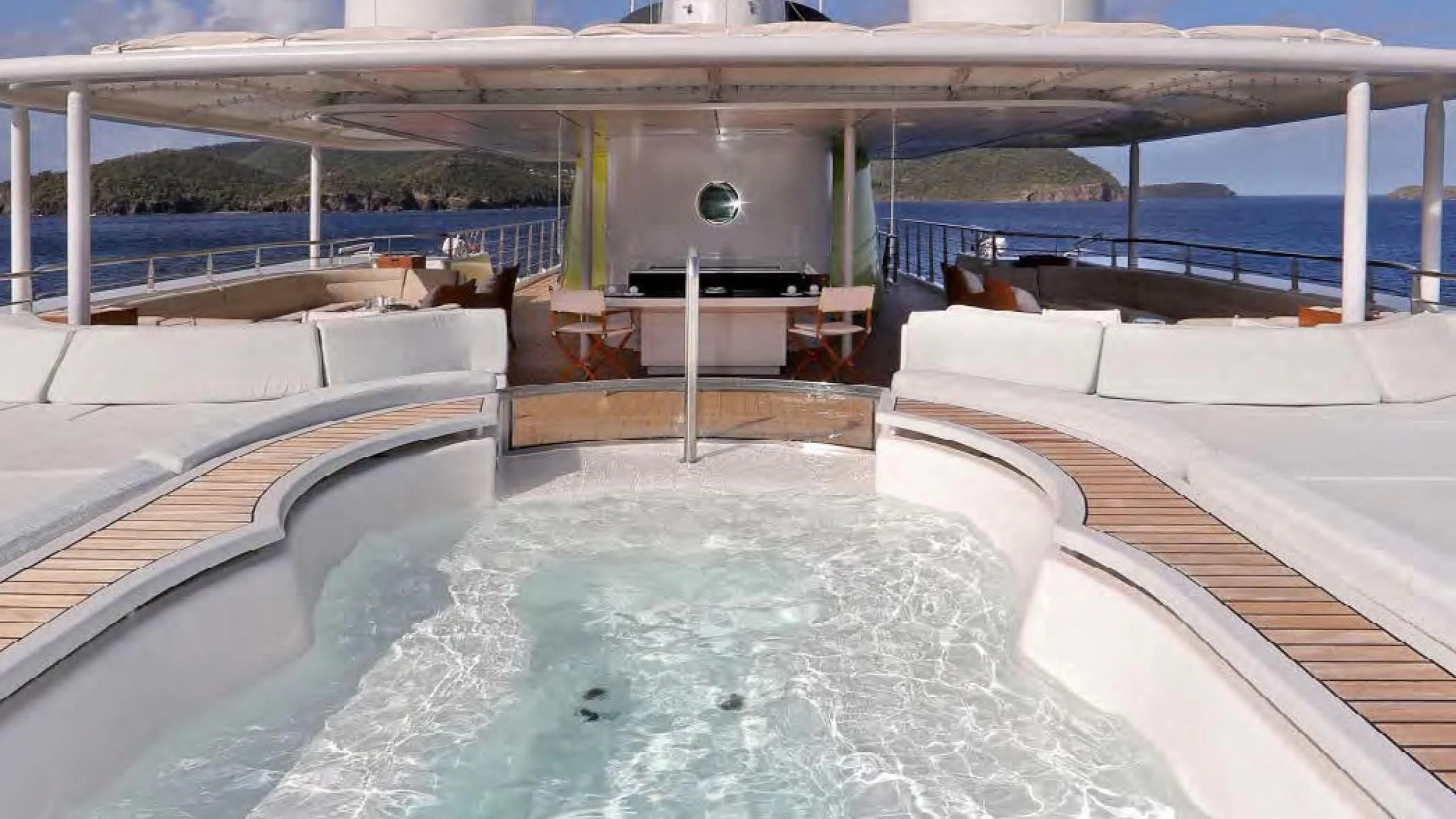 a swimming pool with a large deck and a large pool aboard YERSIN Yacht for Charter
