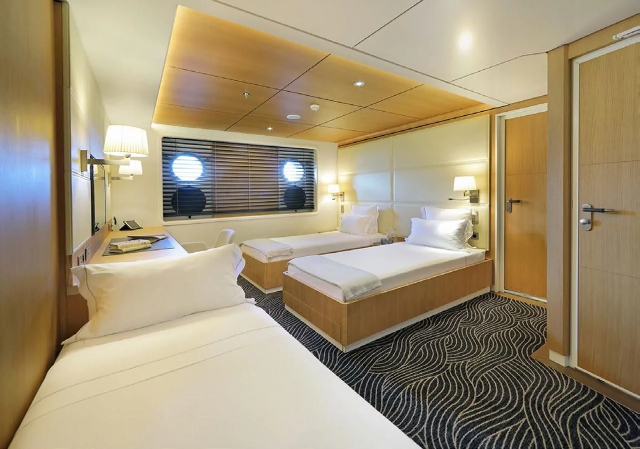 a room with a couple of beds aboard YERSIN Yacht for Charter