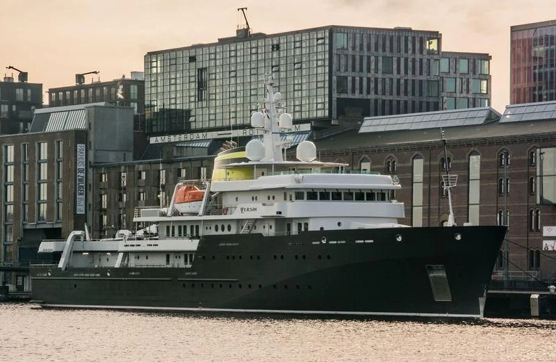 a large boat in front of a building aboard YERSIN Yacht for Charter