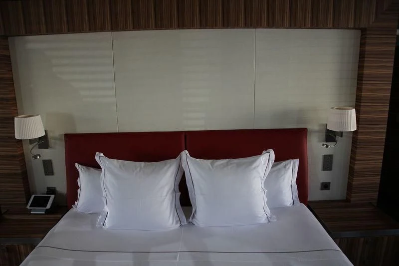 a bed with white sheets aboard YERSIN Yacht for Charter