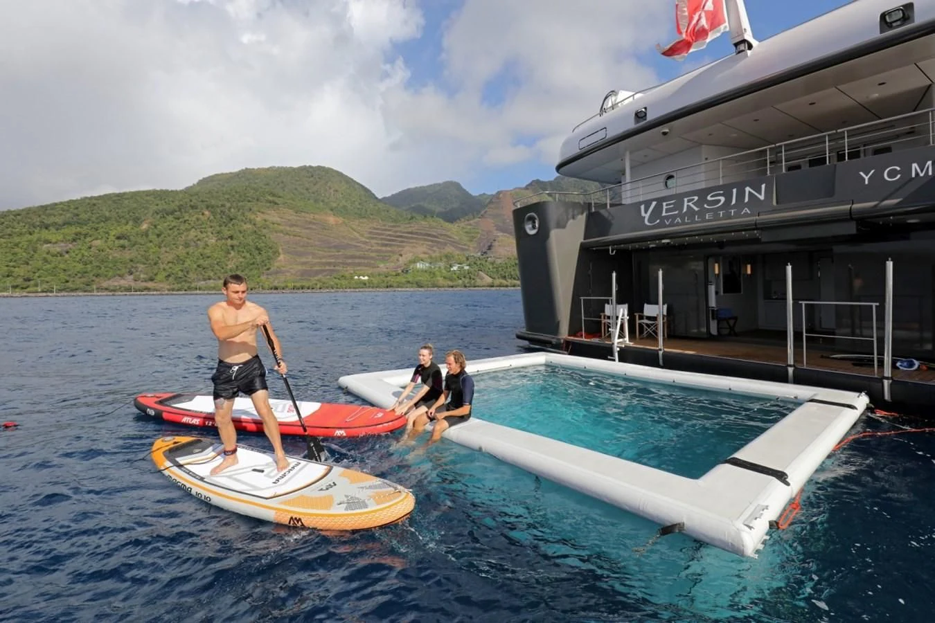 a group of people on surfboards aboard YERSIN Yacht for Charter