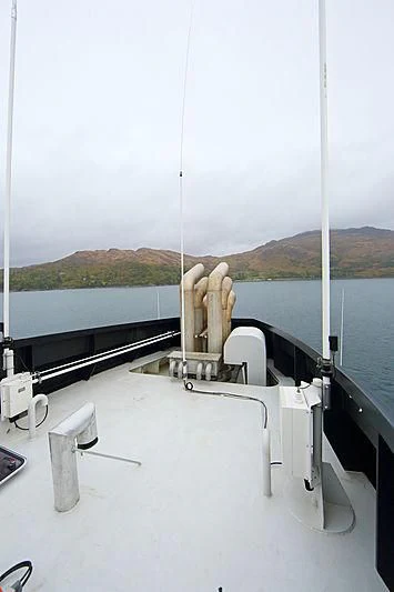 a hand holding a piece of wood aboard YERSIN Yacht for Charter
