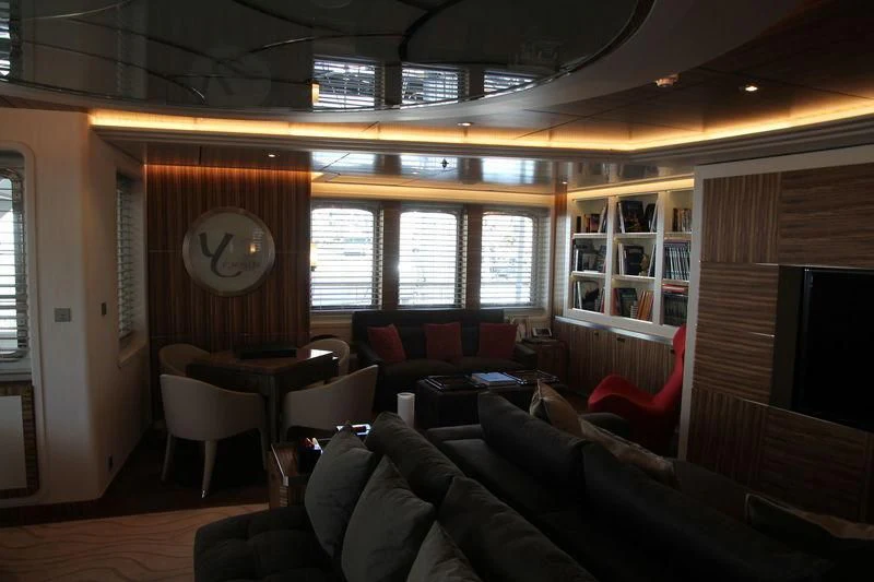 a room with couches and a clock aboard YERSIN Yacht for Charter