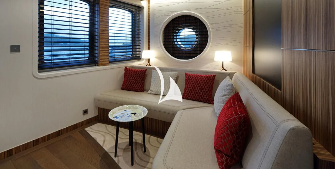a living room with a couch and a window aboard YERSIN Yacht for Charter
