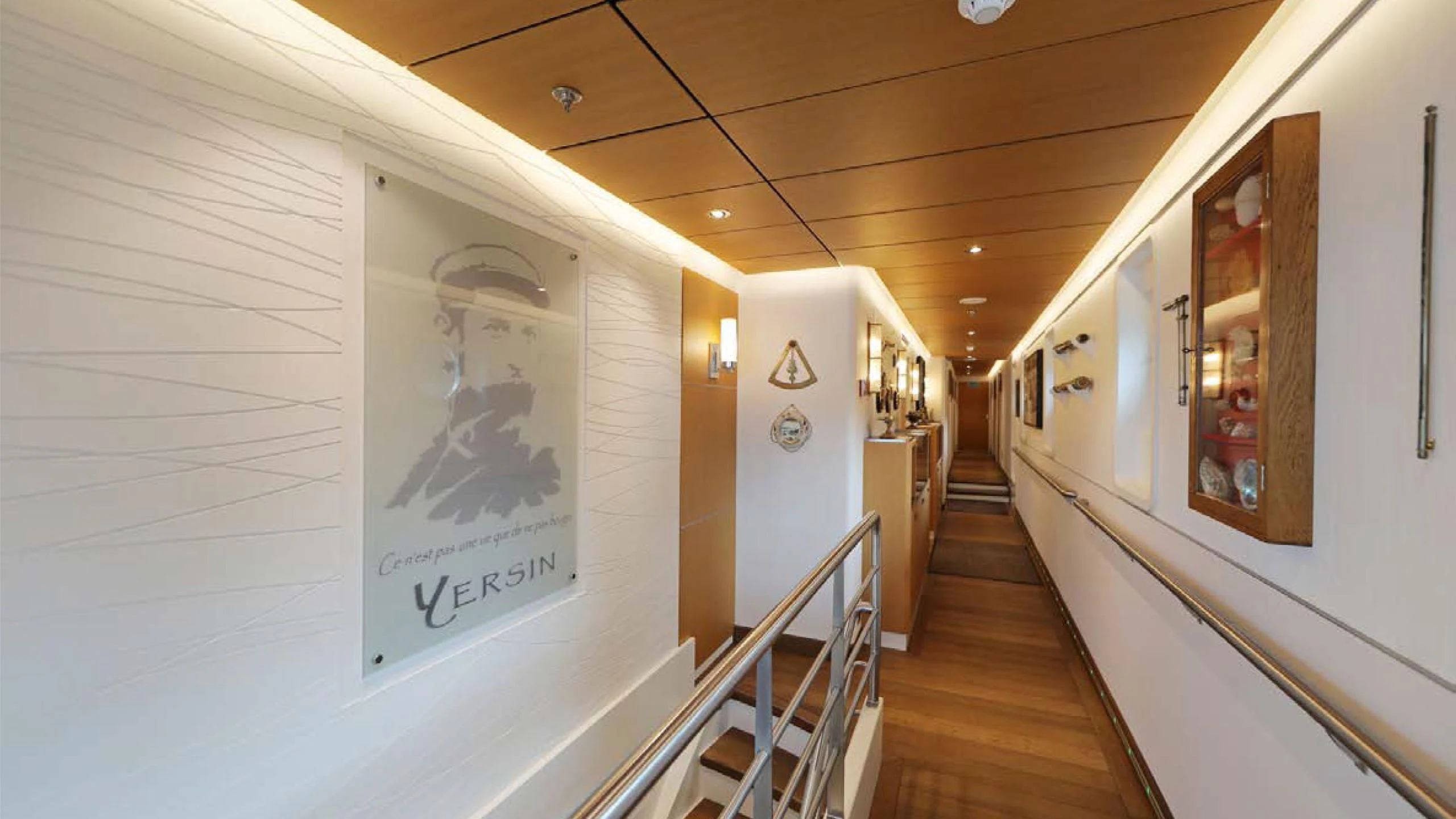 a hallway with a large poster on the wall aboard YERSIN Yacht for Charter