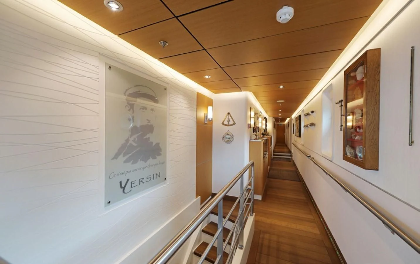 a hallway with art on the wall aboard YERSIN Yacht for Charter