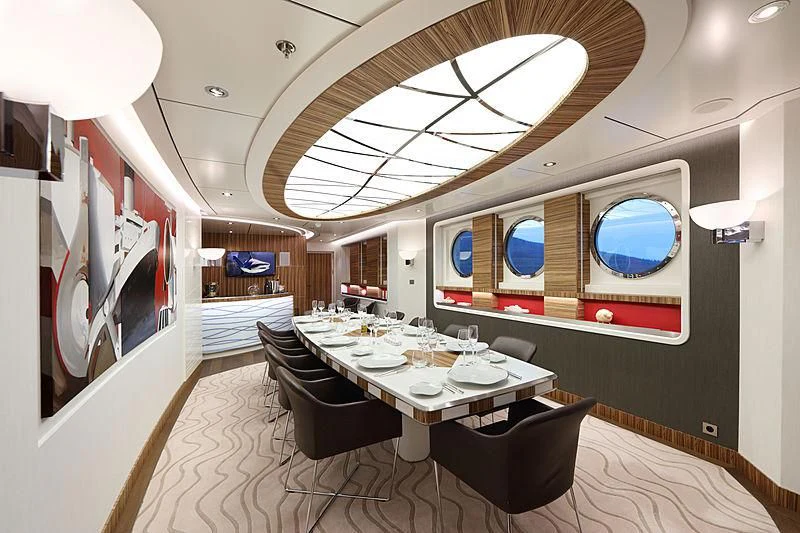 a room with a table and chairs aboard YERSIN Yacht for Charter