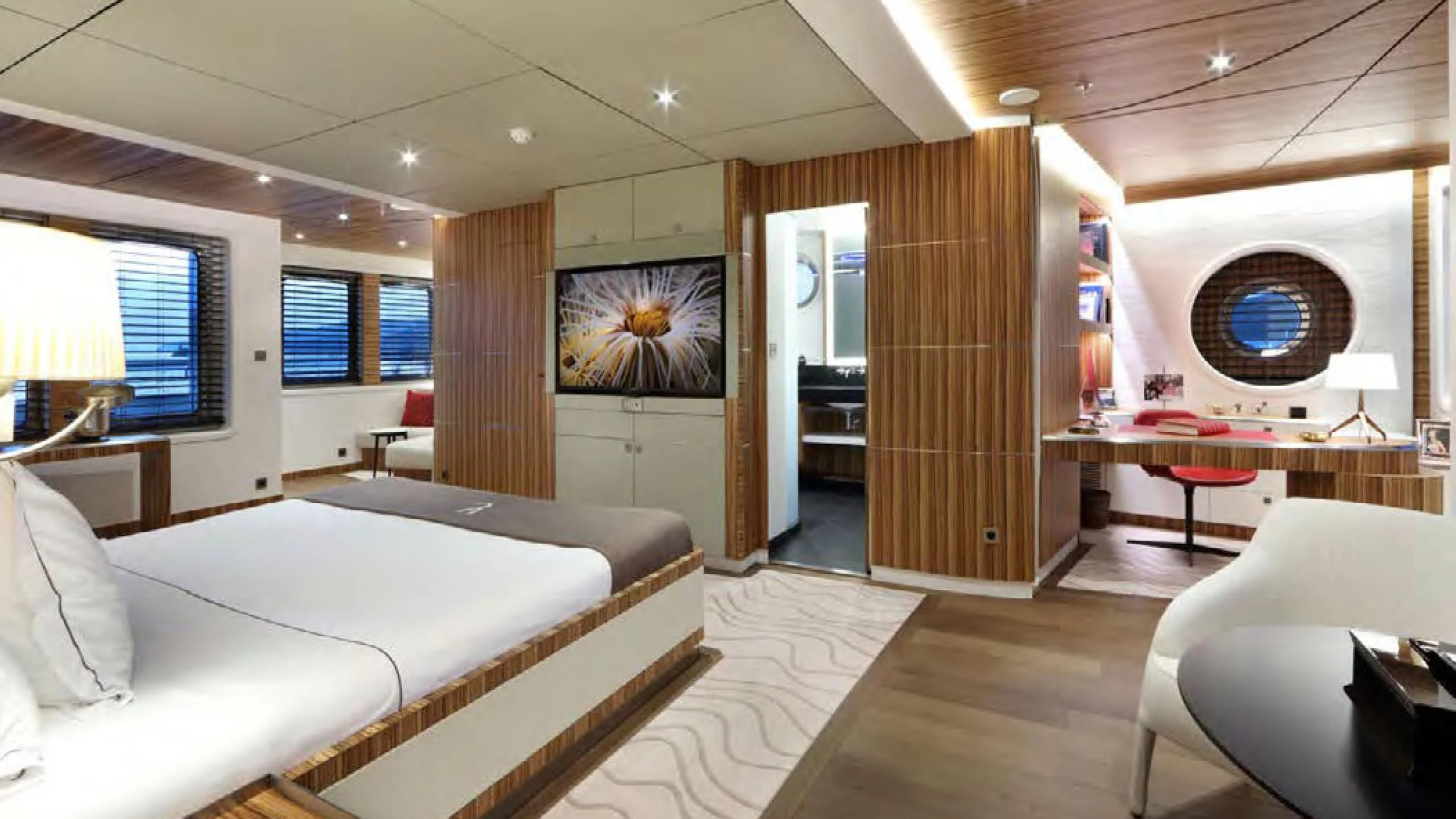 a room with a bed and a desk aboard YERSIN Yacht for Charter
