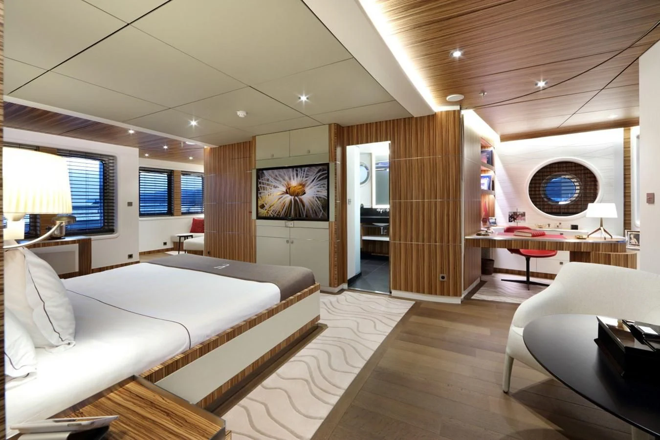 a room with a bed and a desk aboard YERSIN Yacht for Charter