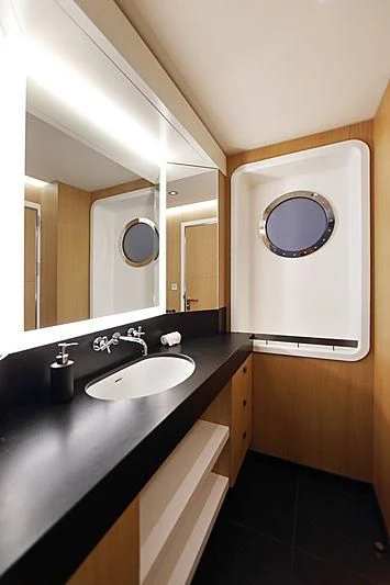 a bathroom with a sink and a mirror aboard YERSIN Yacht for Charter