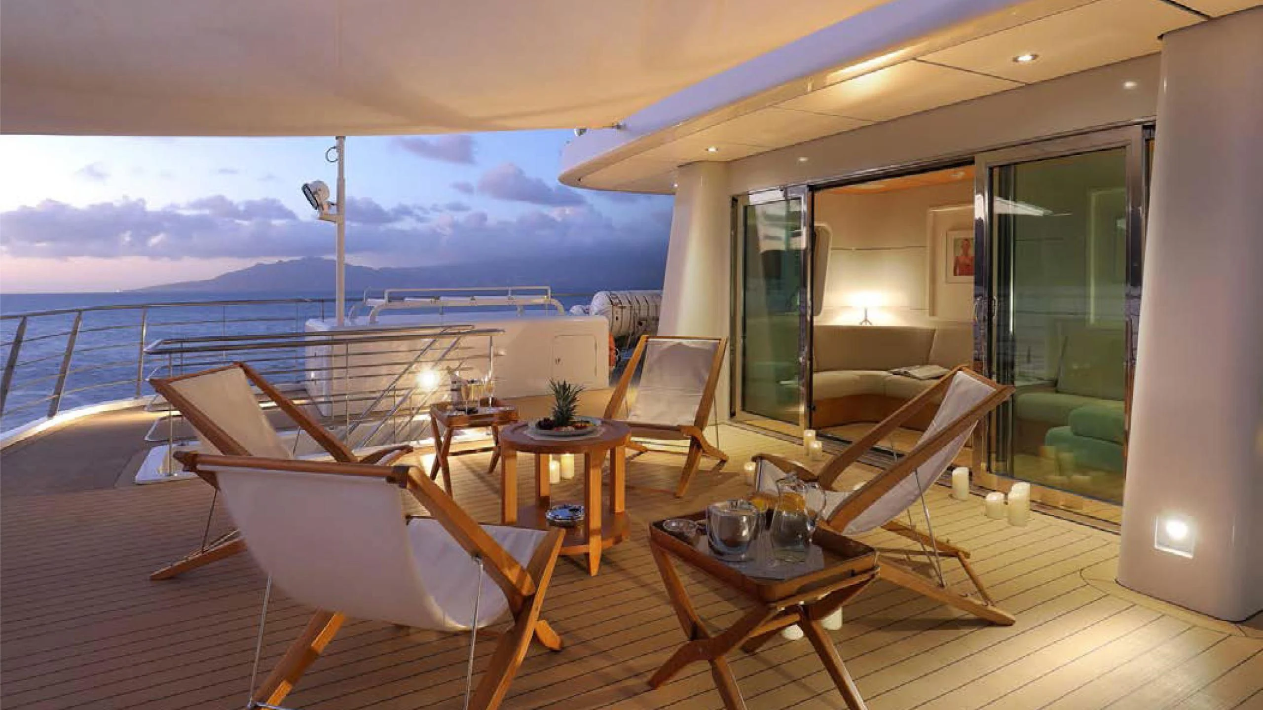 a room with a table chairs and a view of the ocean aboard YERSIN Yacht for Charter