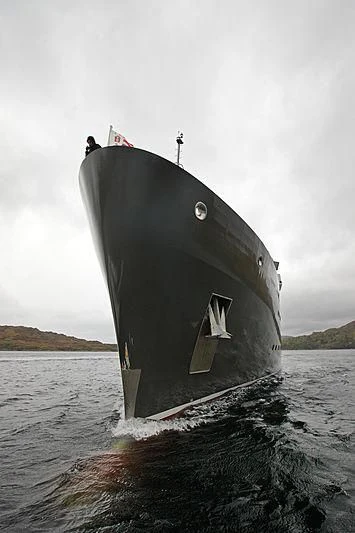 a large grey ship on the water aboard YERSIN Yacht for Charter