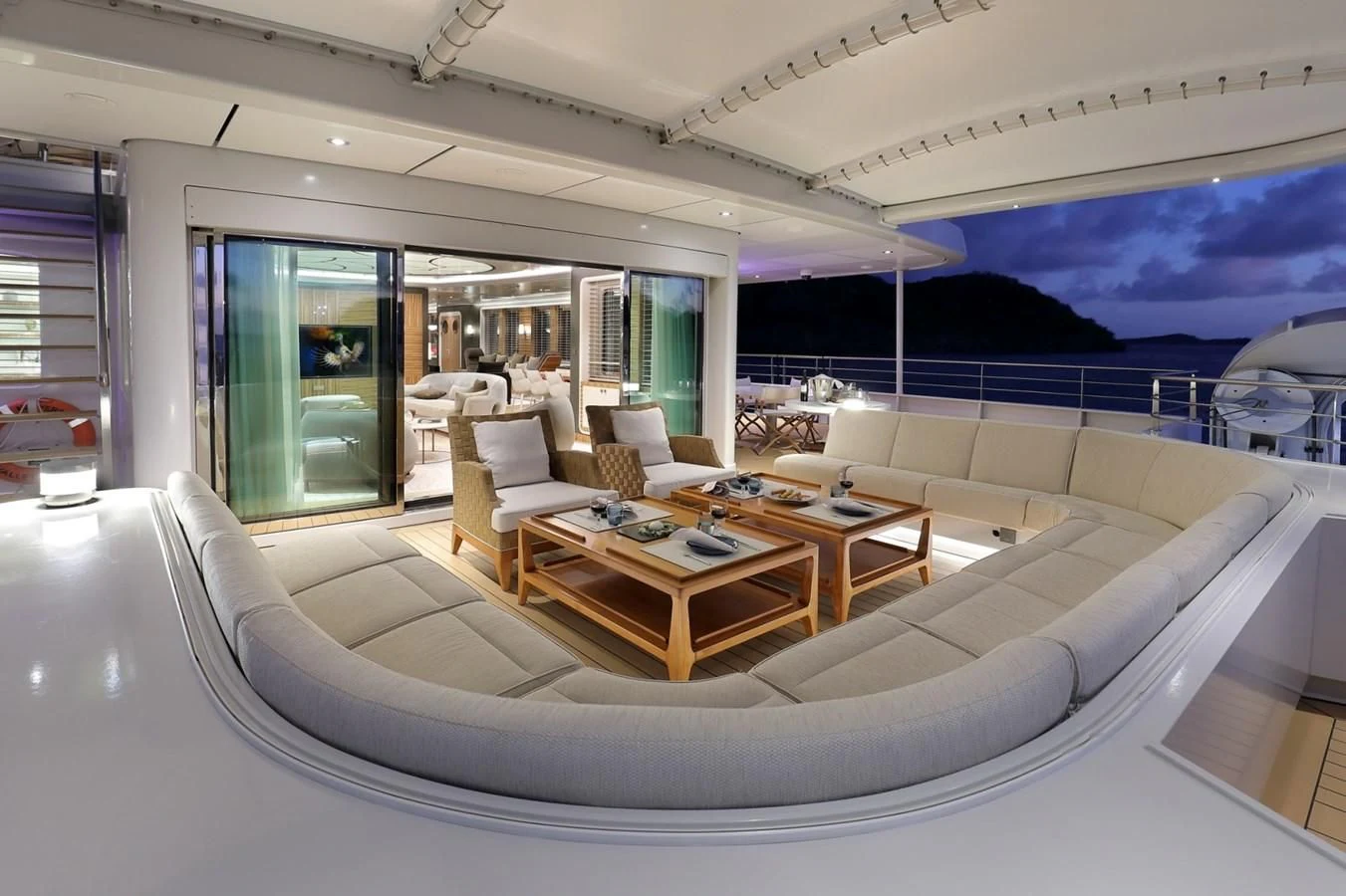 a modern living room with a large white couch and a large window aboard YERSIN Yacht for Charter