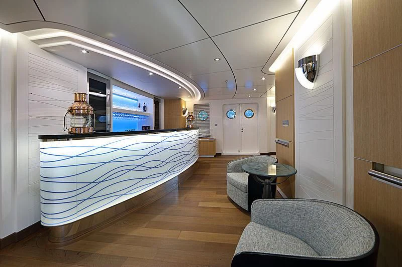 a large room with a large blue pool table and a couch aboard YERSIN Yacht for Charter