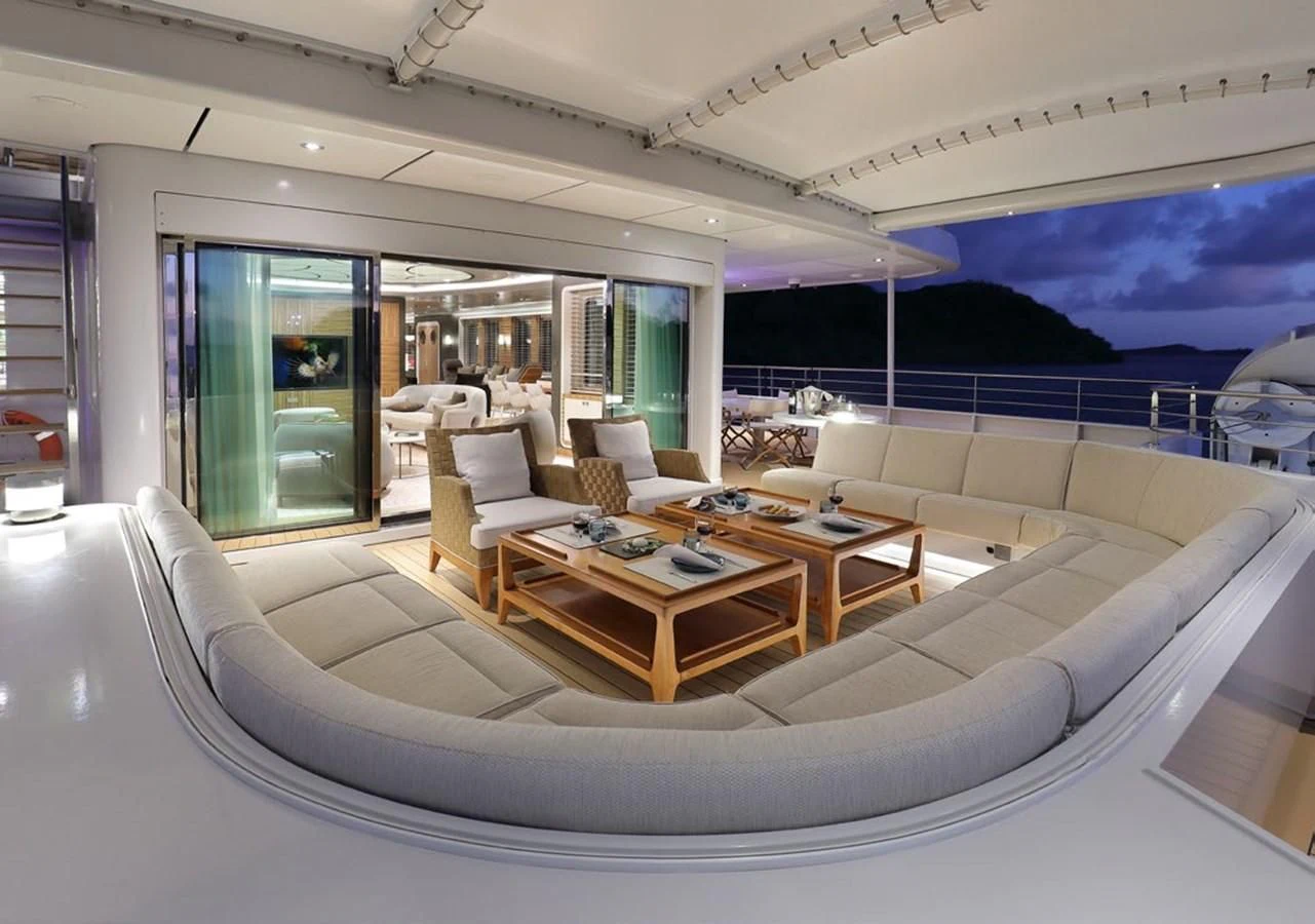 a living room with a large white couch and a large window aboard YERSIN Yacht for Charter