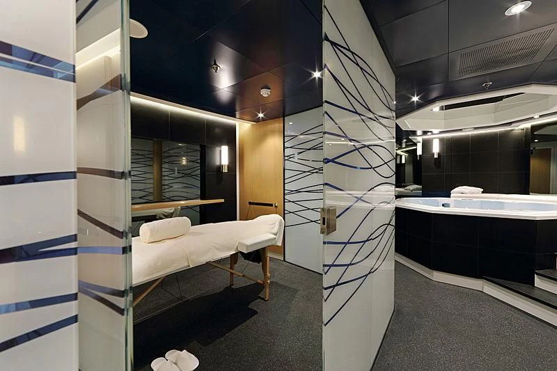 a room with a bed and a large mirror aboard YERSIN Yacht for Charter