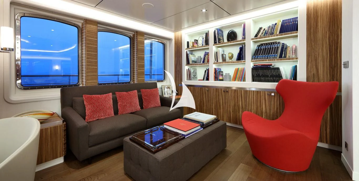 a living room with a red chair aboard YERSIN Yacht for Charter