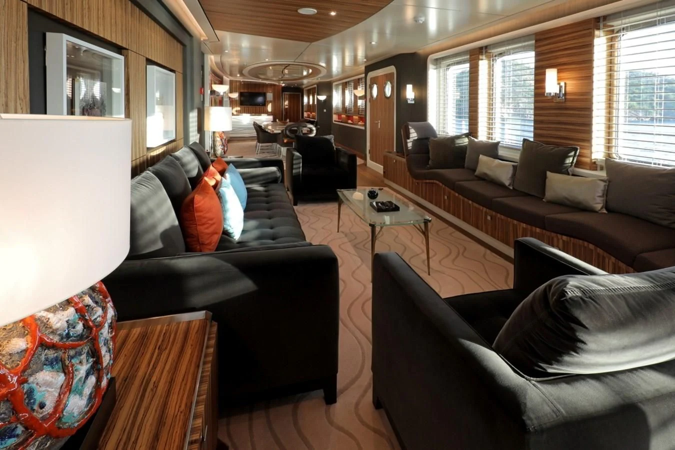a living room with leather couches and a large window aboard YERSIN Yacht for Charter