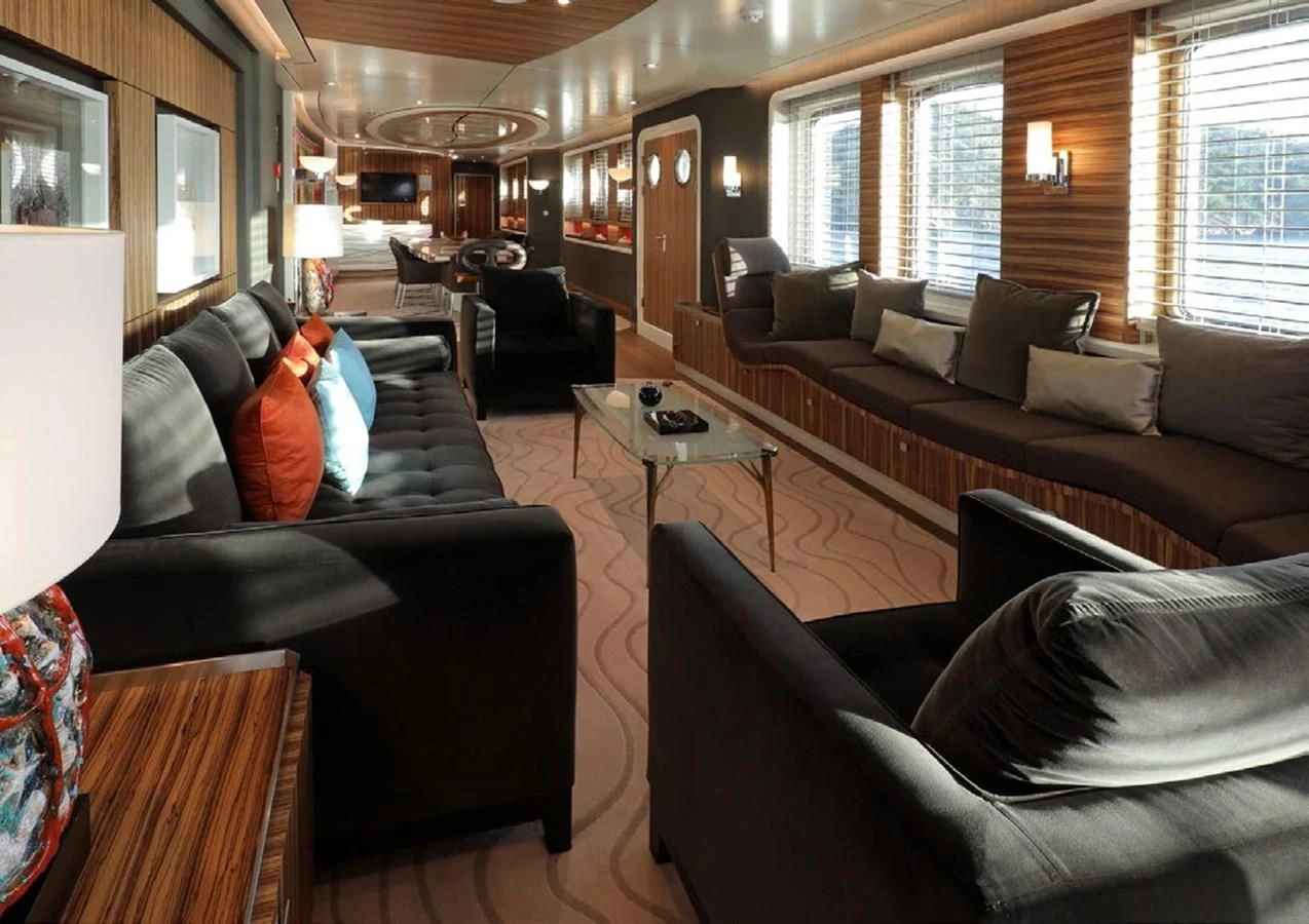 a living room with leather couches and a coffee table aboard YERSIN Yacht for Charter