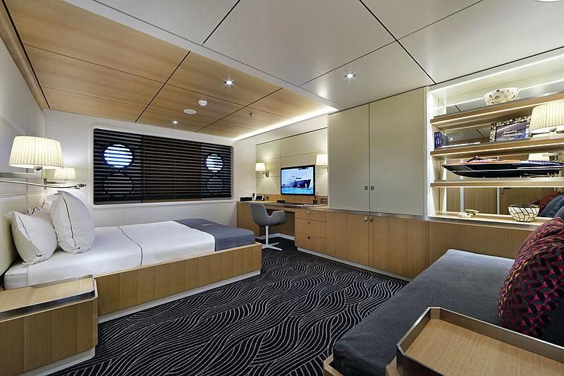 a room with a bed and a couch aboard YERSIN Yacht for Charter