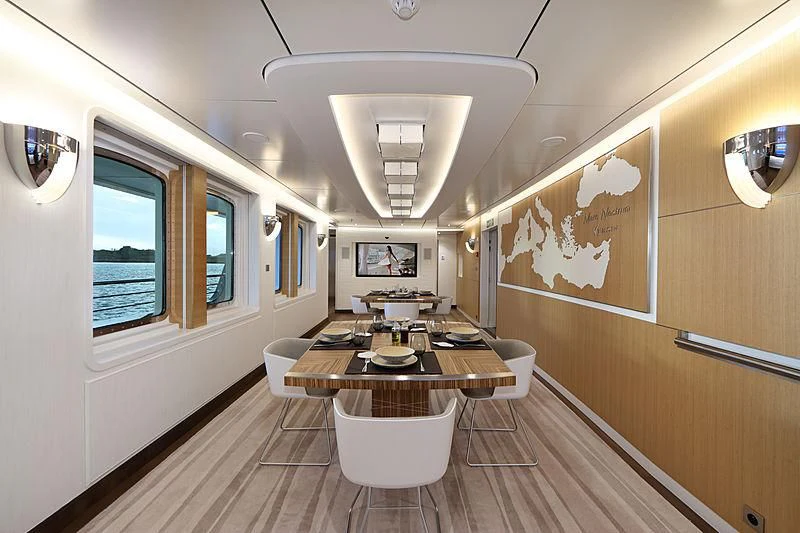 a room with a table and chairs aboard YERSIN Yacht for Charter