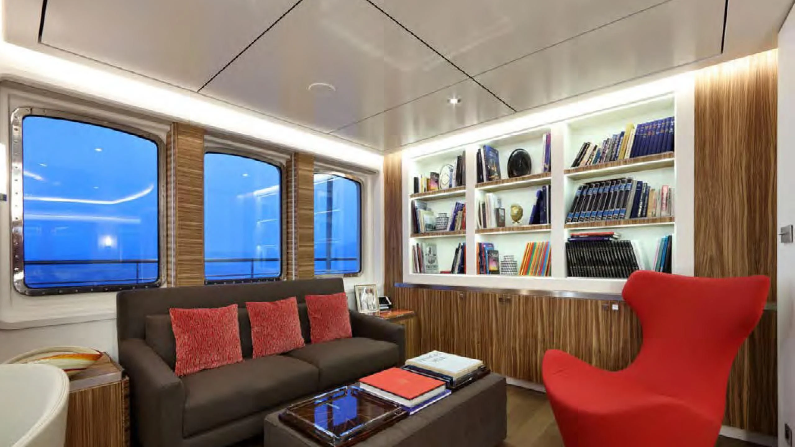 a living room with a bookcase and a couch aboard YERSIN Yacht for Charter