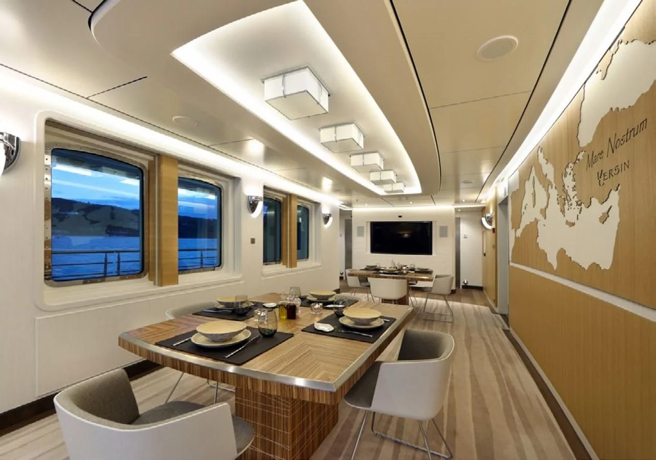 a room with a table and chairs aboard YERSIN Yacht for Charter