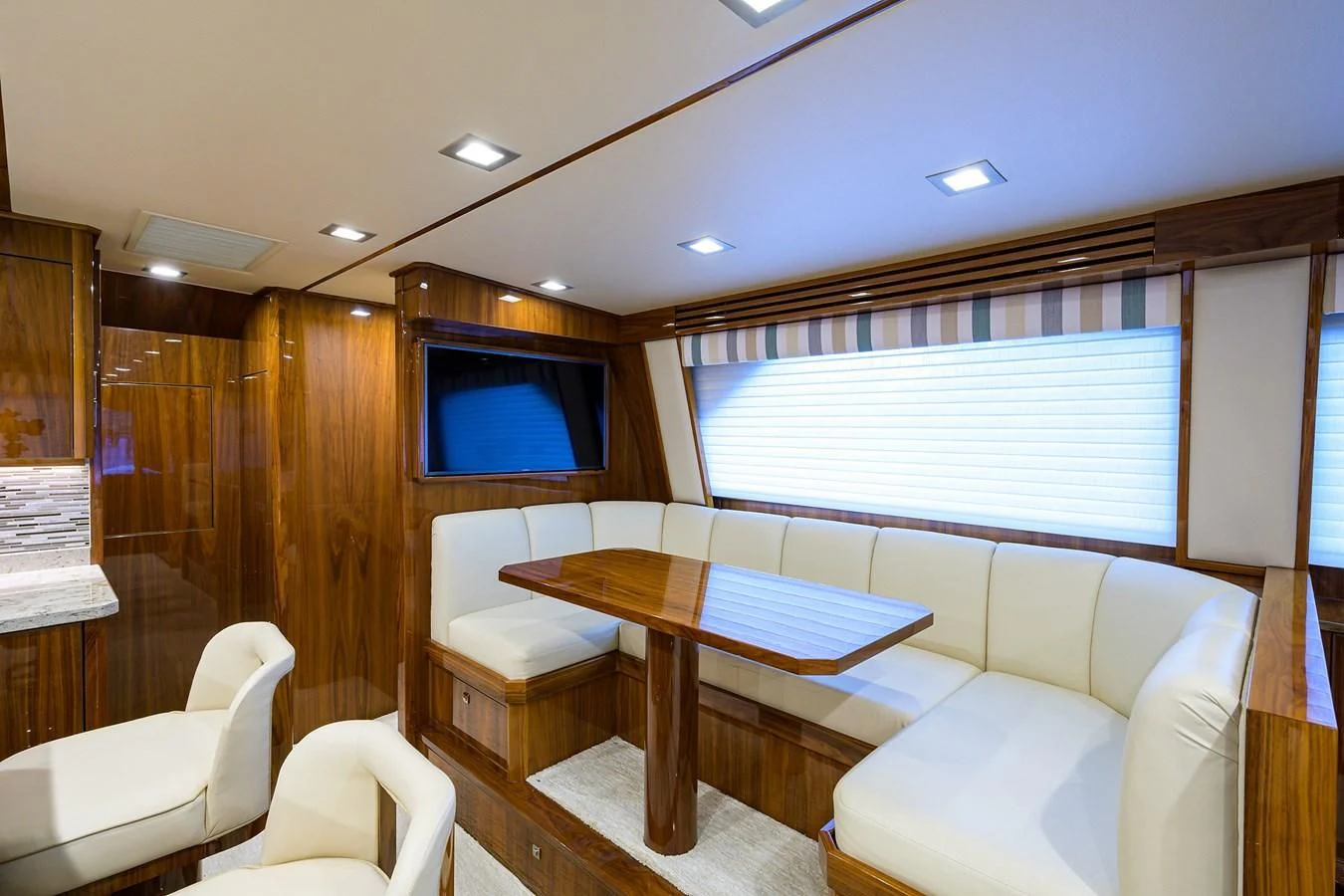 a room with a table and chairs aboard ABSOLUT Yacht for Sale