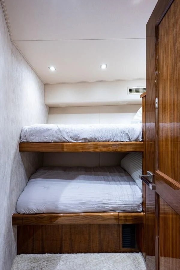 a bed with a wooden frame aboard ABSOLUT Yacht for Sale