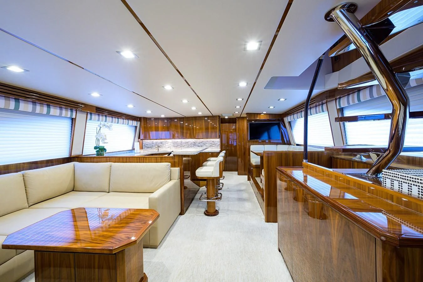 a room with a couch and a table and a window aboard ABSOLUT Yacht for Sale