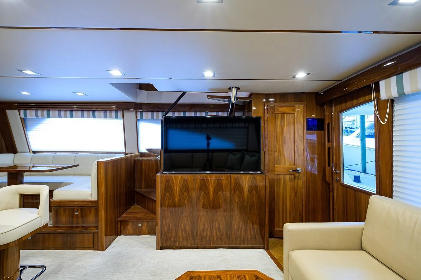 a room with a tv and couches aboard ABSOLUT Yacht for Sale