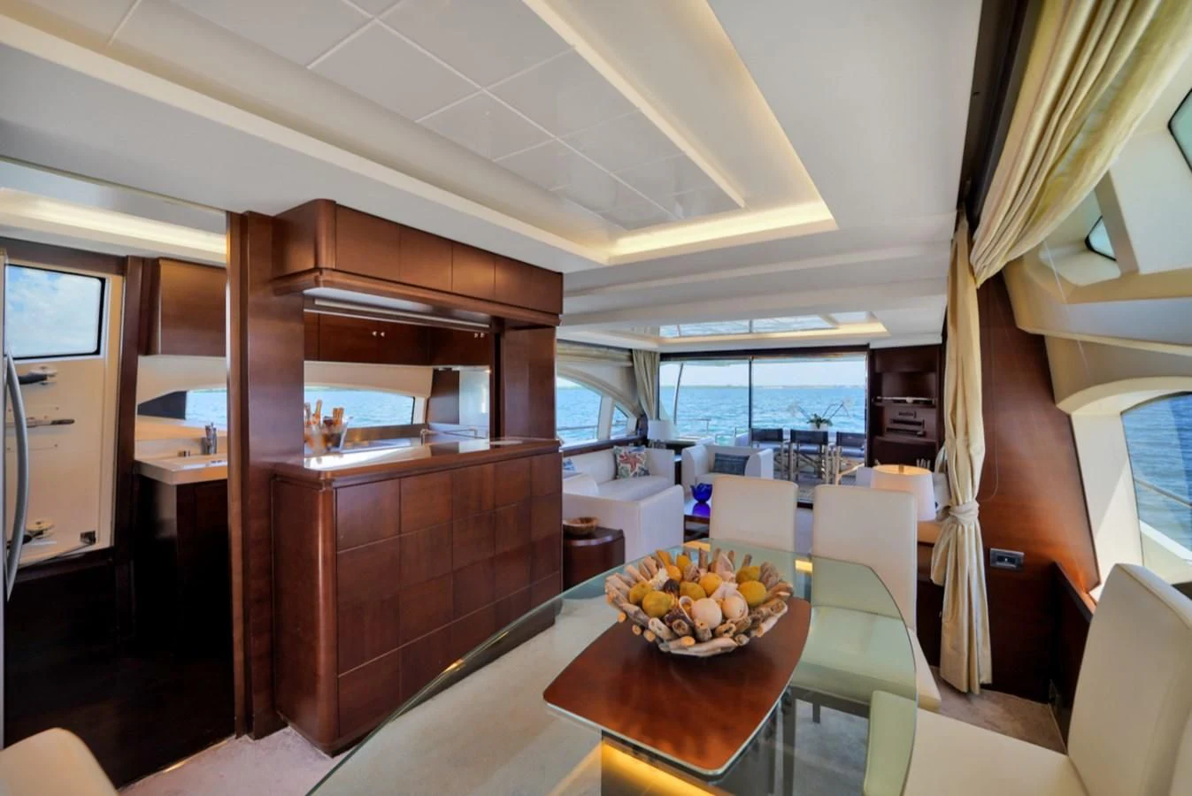 a kitchen with a table and chairs aboard TABATA Yacht for Sale