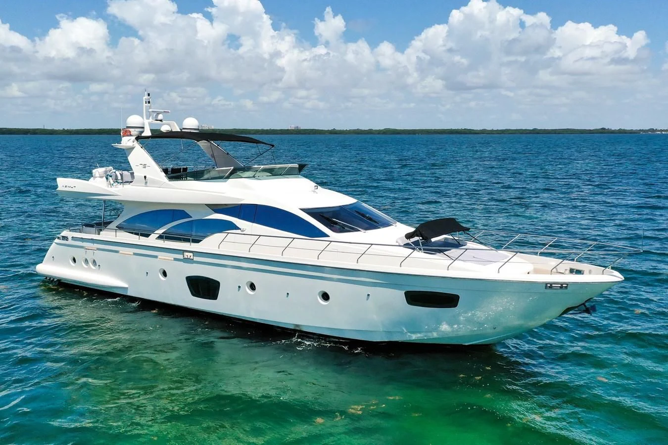 a white yacht in the water aboard TABATA Yacht for Sale