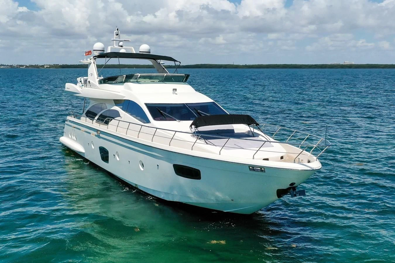 a white yacht in the water aboard TABATA Yacht for Sale