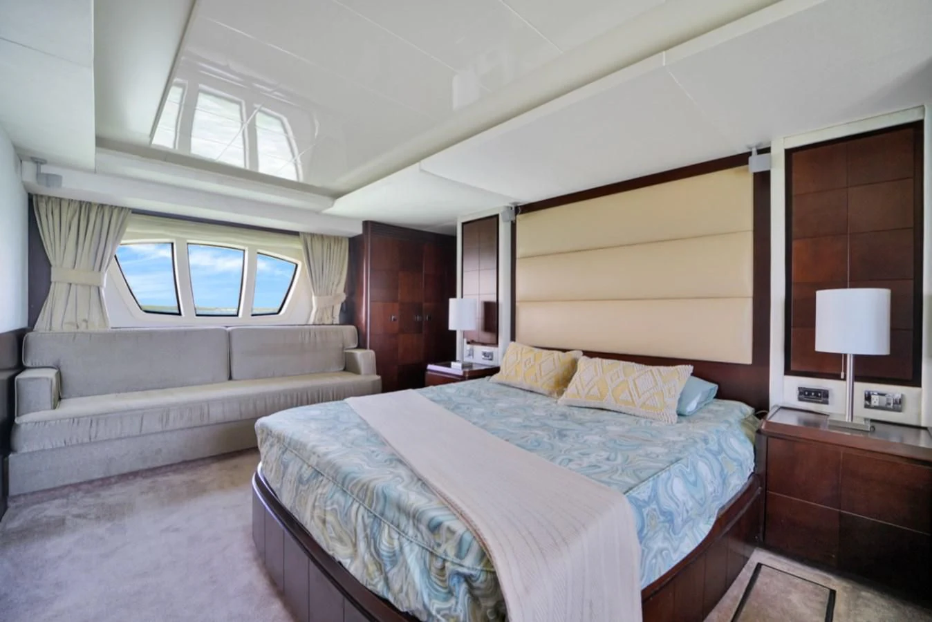 a bedroom with a bed and a couch aboard TABATA Yacht for Sale