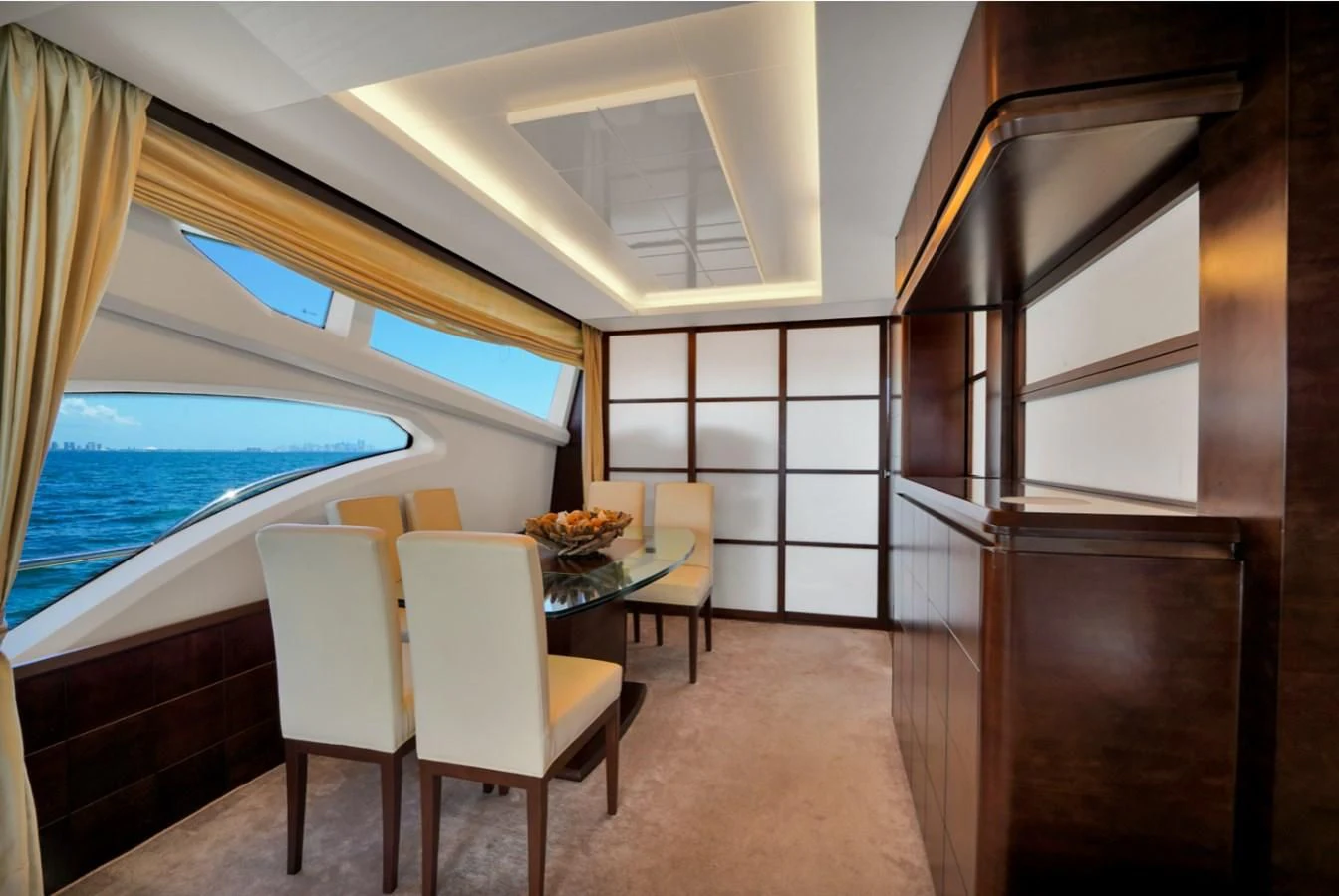 a room with a table chairs and a window aboard TABATA Yacht for Sale