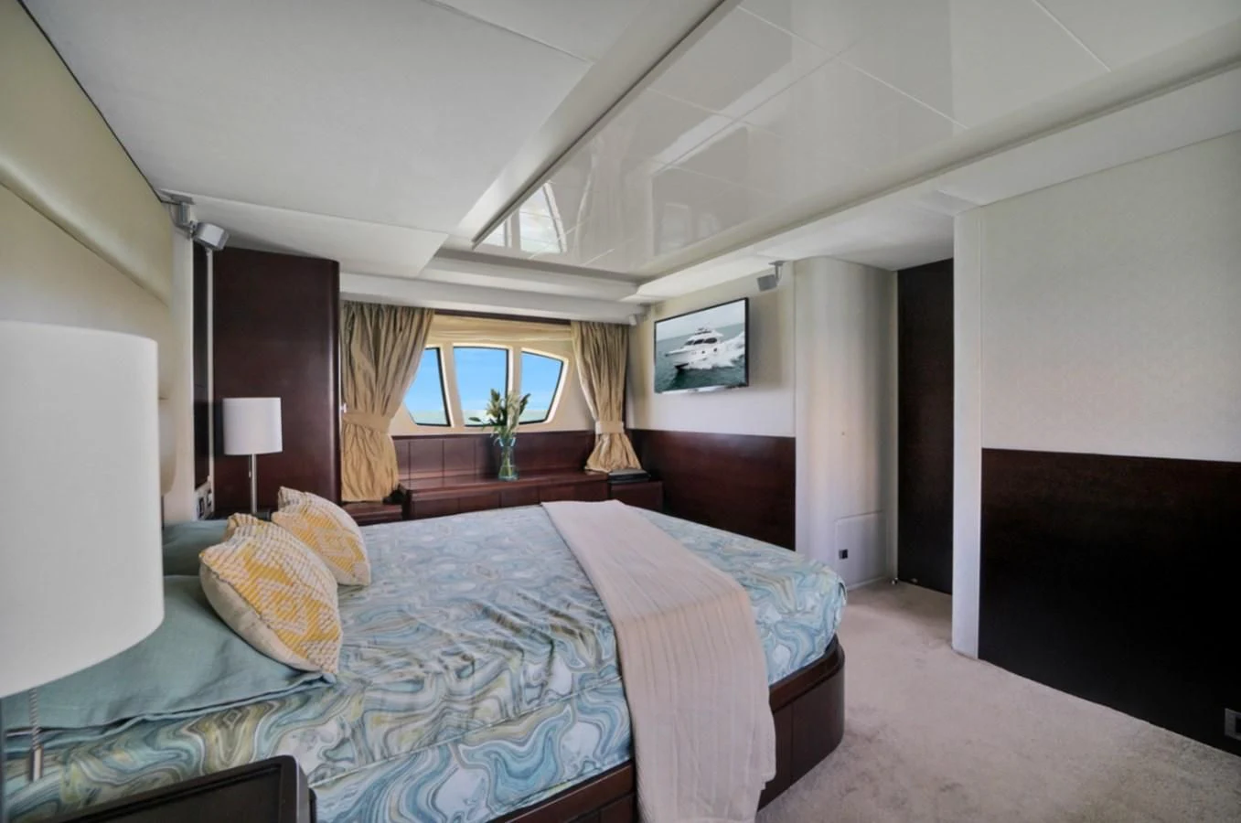 a bedroom with a bed and a window aboard TABATA Yacht for Sale