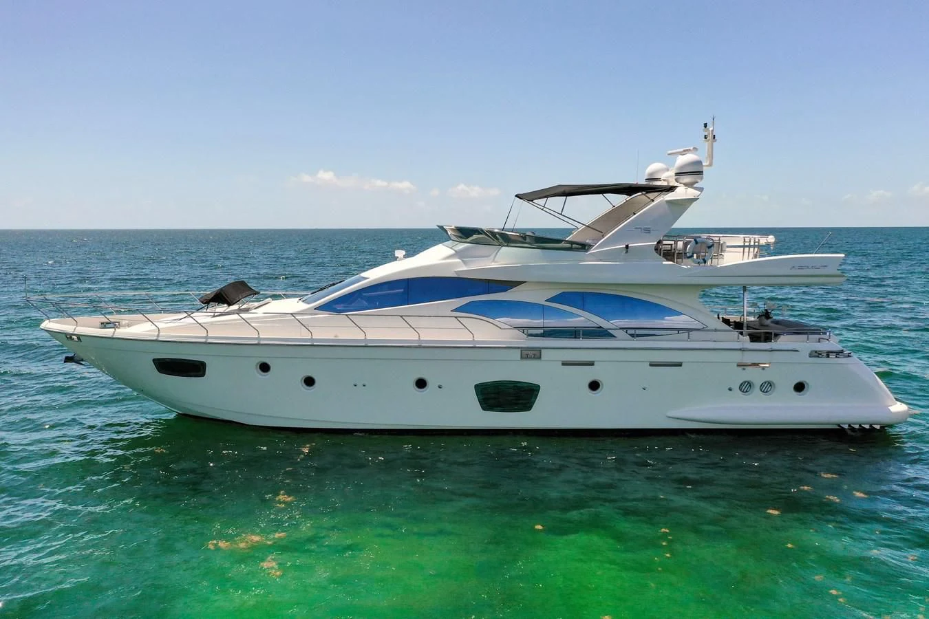 a white yacht in the water aboard TABATA Yacht for Sale