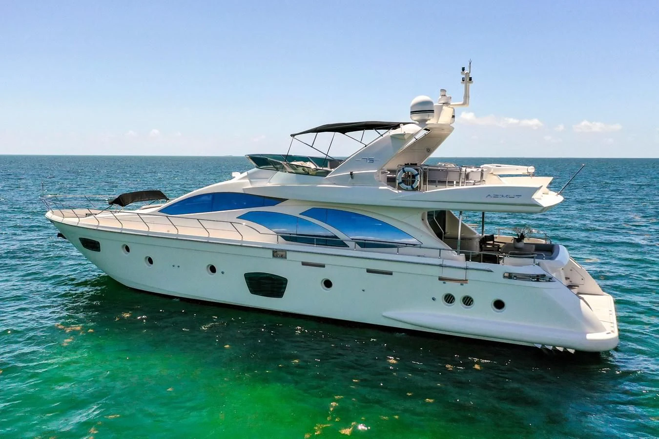 a white yacht in the water aboard TABATA Yacht for Sale