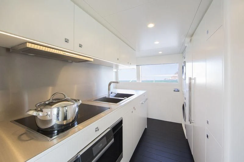 a kitchen with a stove and a sink aboard NICOSTASIA Yacht for Sale