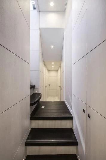 a bathroom with a black counter and white tile walls aboard NICOSTASIA Yacht for Sale