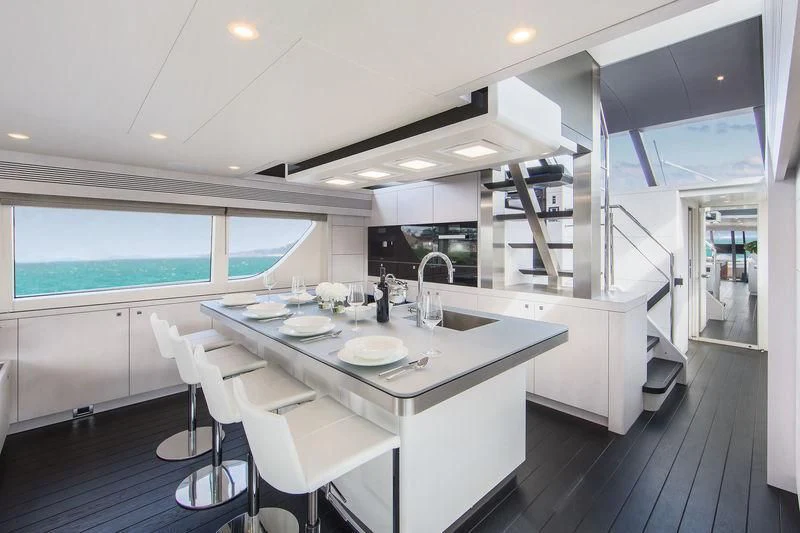 a kitchen with a table and chairs aboard NICOSTASIA Yacht for Sale