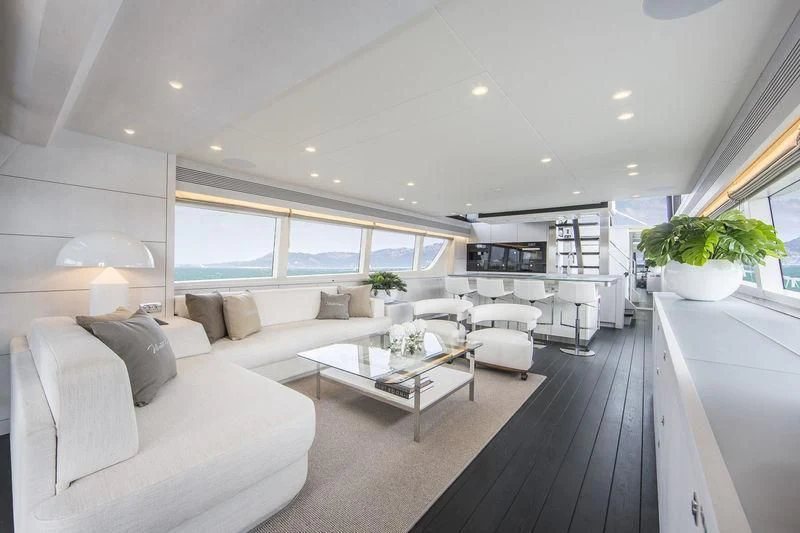 a modern living room with a large window aboard NICOSTASIA Yacht for Sale