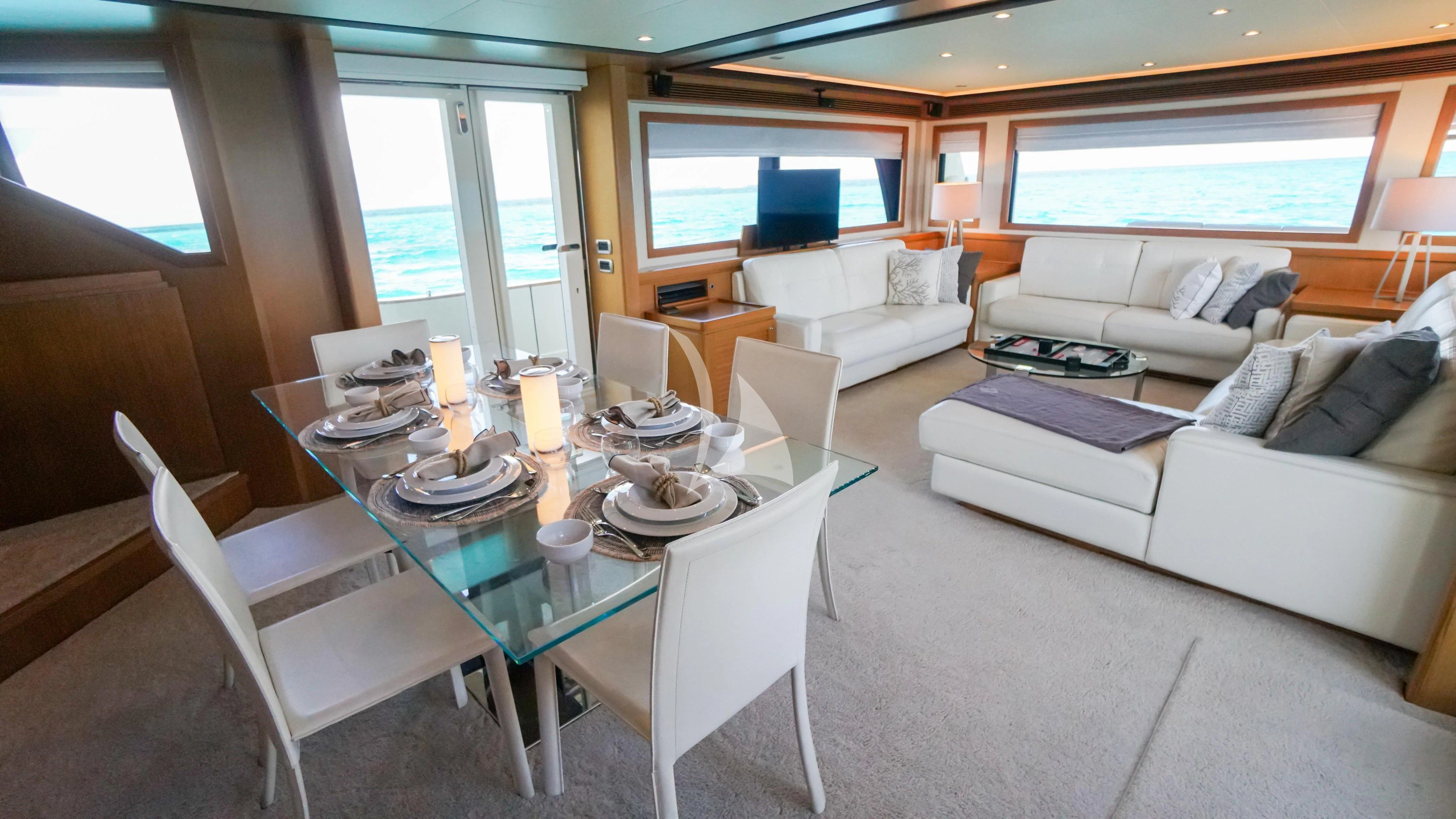 a large white dining table in a living room aboard NOMADA Yacht for Charter